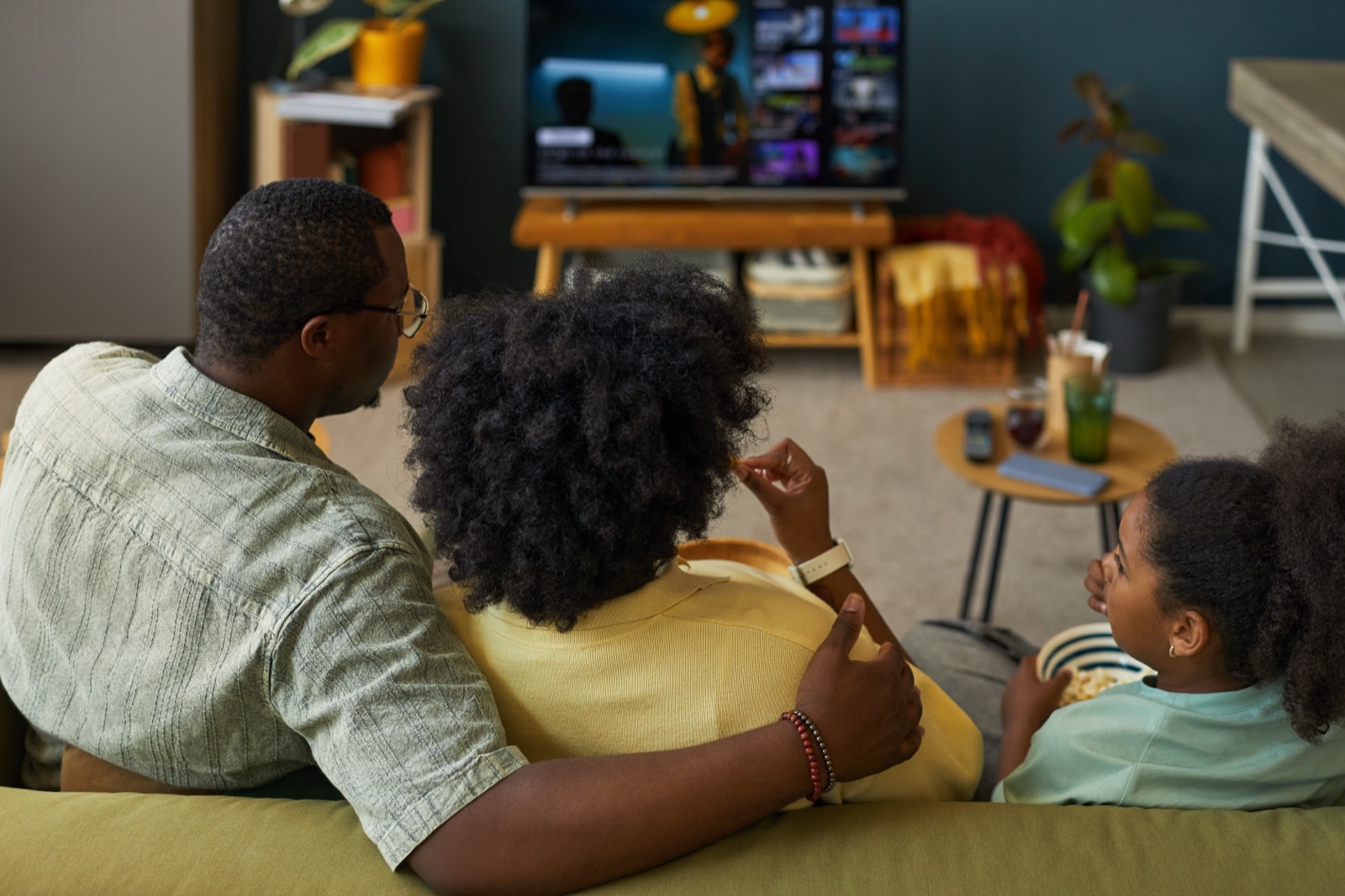 A family watching connected TV at home, the household Loyal resolves across CTV and mobile